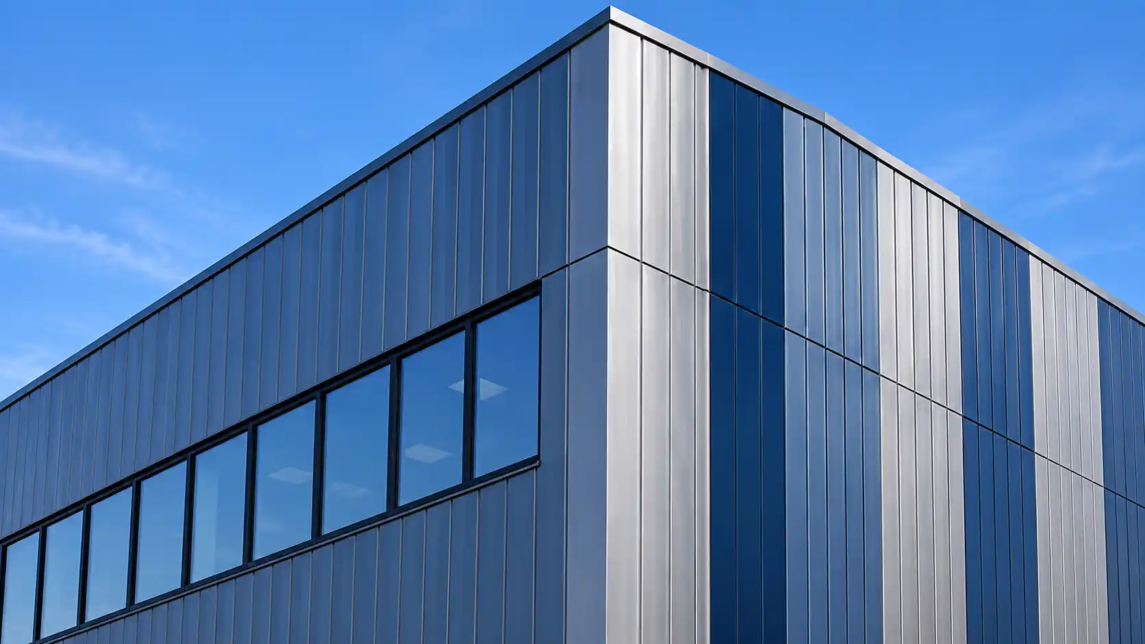 Modern commercial building with blue and silver architectural metal wall panels.